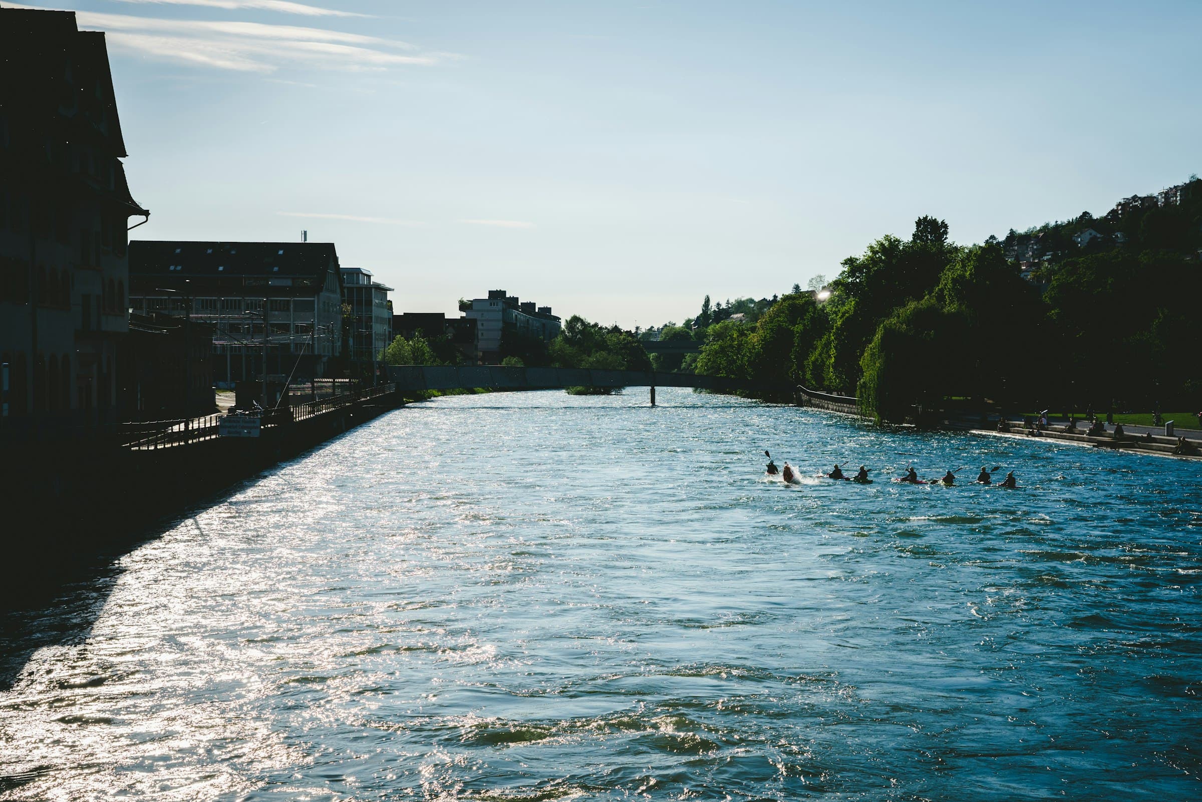 Swimmers drifting down the turquoise Limmat in summer