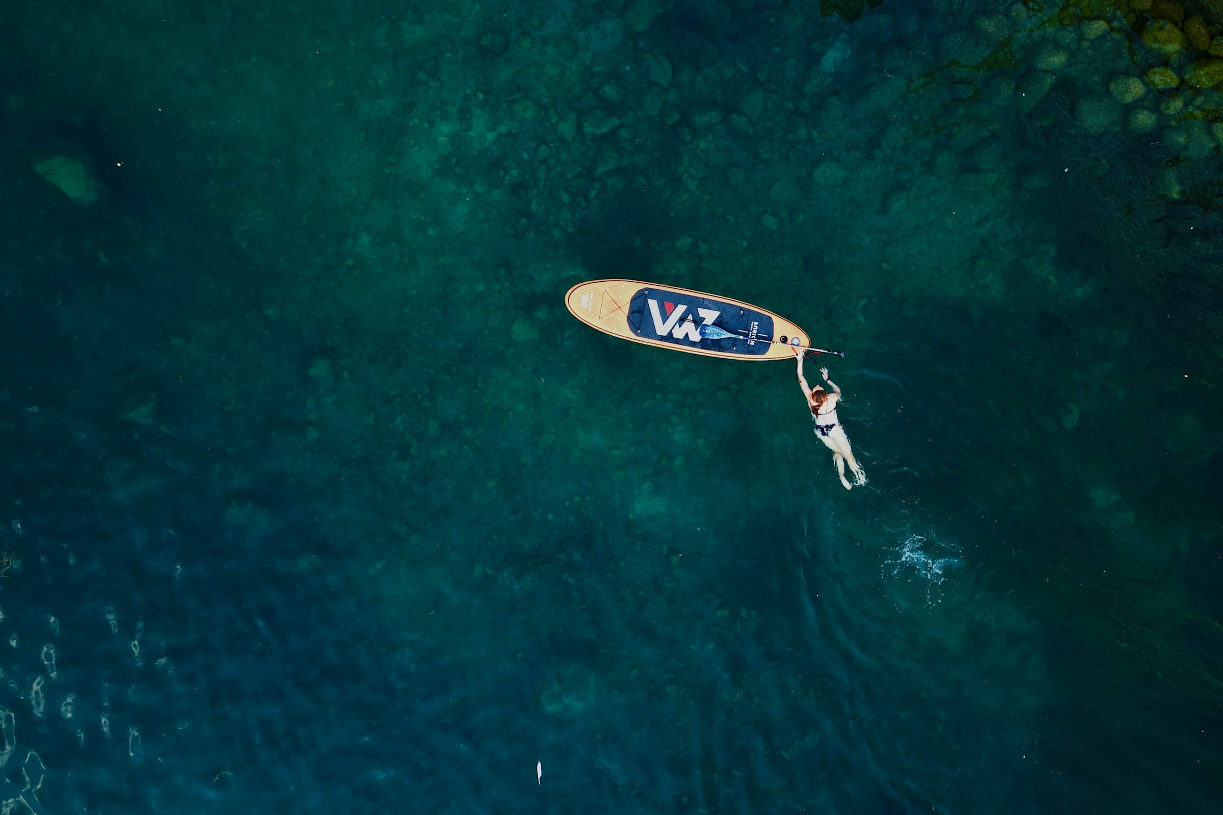 The Limmat from above: turquoise water and a single paddleboarder