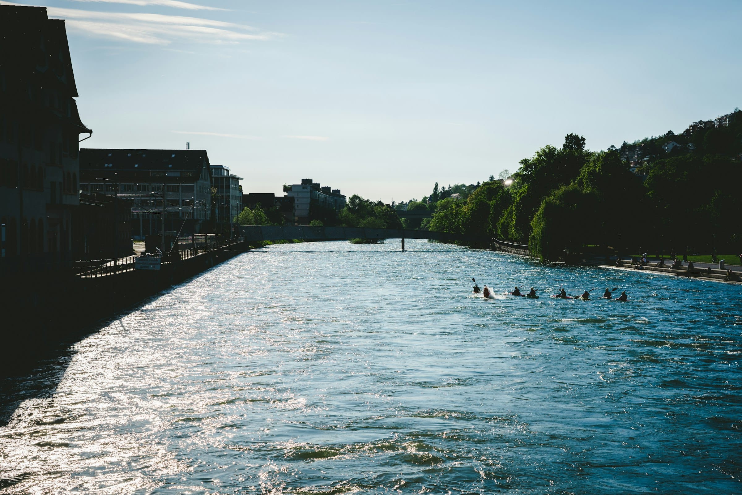 Swimmers drifting down the turquoise Limmat in summer
